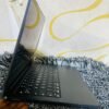 Real Space Gray MacBook Air M2 on display at MicroStar Andy shop Kampala - side view showing ports, keyboard and trackpad condition