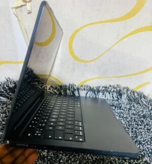 Real Space Gray MacBook Air M2 on display at MicroStar Andy shop Kampala - side view showing ports, keyboard and trackpad condition